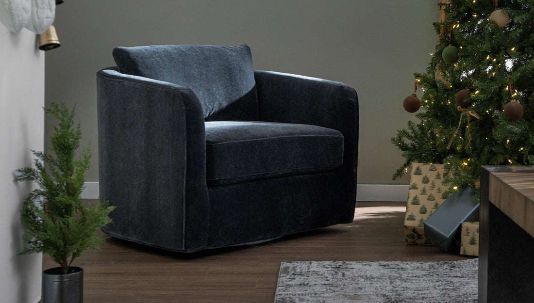 An accent chair next to a Christmas tree