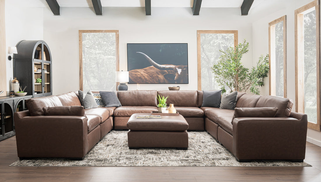 A brown leather sectional couch in a living room
